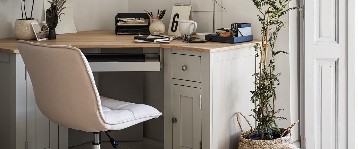 corner desk with wooden desktop and neutral colour office chair