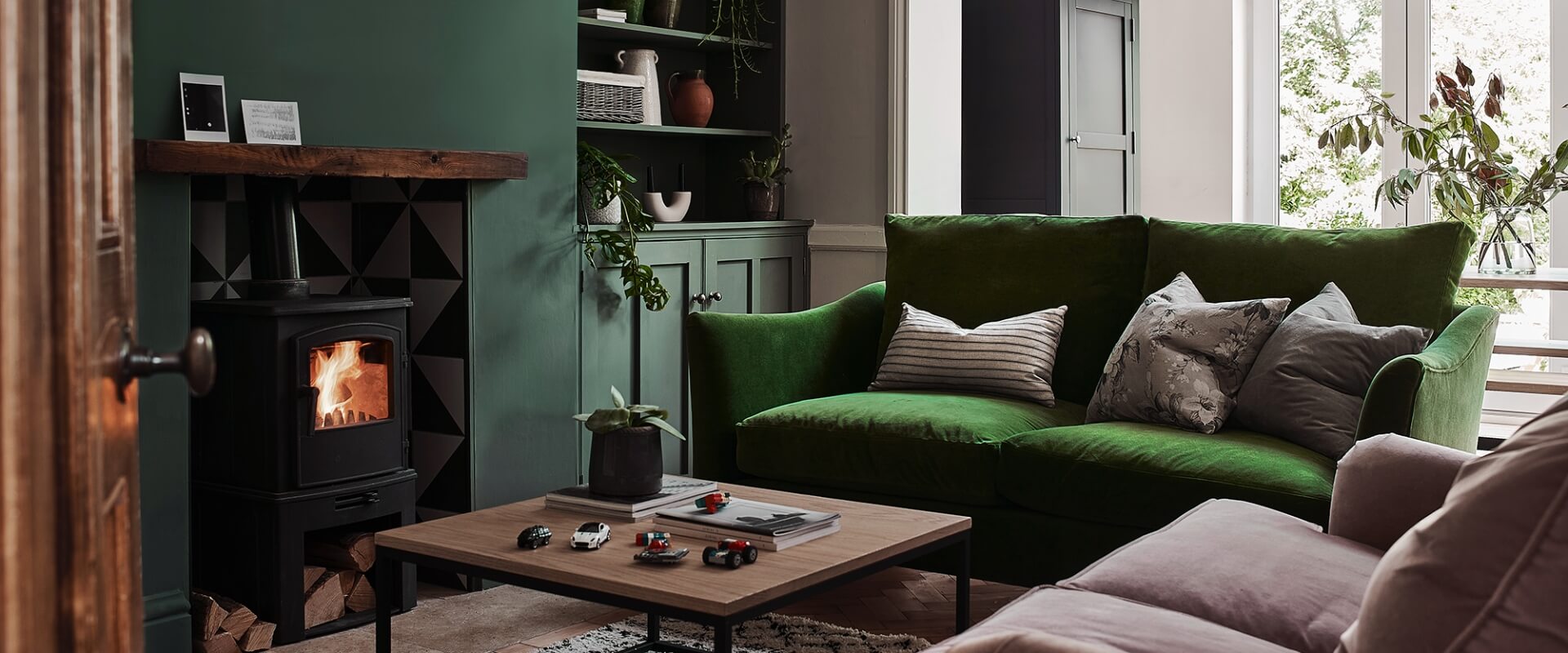 Cosy bright green font room with log burner