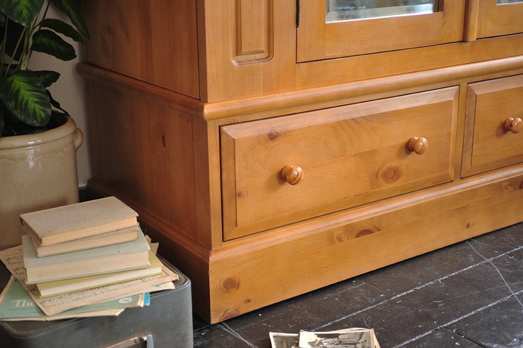 Drawer space, pine wardrobe with mirror, books, vintage suitcase, wooden floor