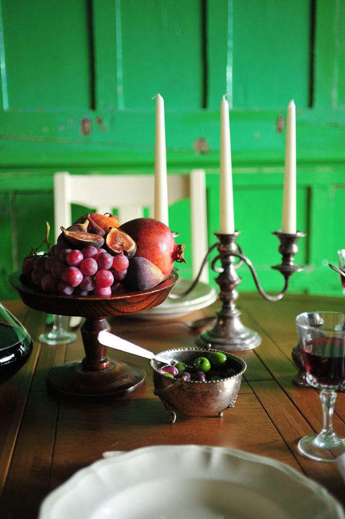 Fruit, candelabra, olives, wine, dining