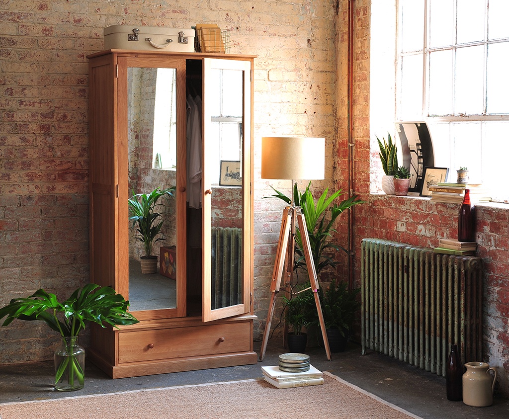 Oak bedroom furniture, Mirrored wardrobe, tripod lamp, exposed brick wall, iron radiator