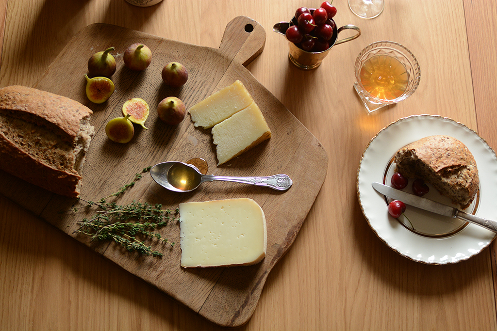 Rustic dining, cheese, chopping board, rustic bread, figs, honey, cherries, thyme
