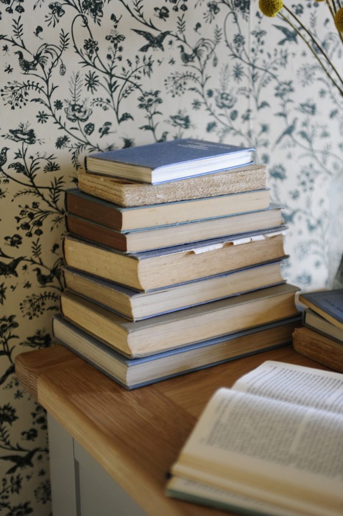 stack of books, blue books, laura ashley wallpaper, Oak furniture