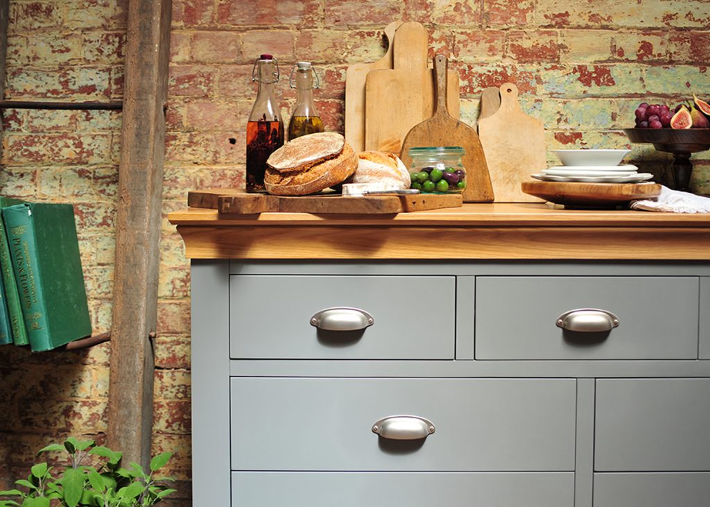 Grey chest, grey furniture, food, oils, bread, wooden chopping boards