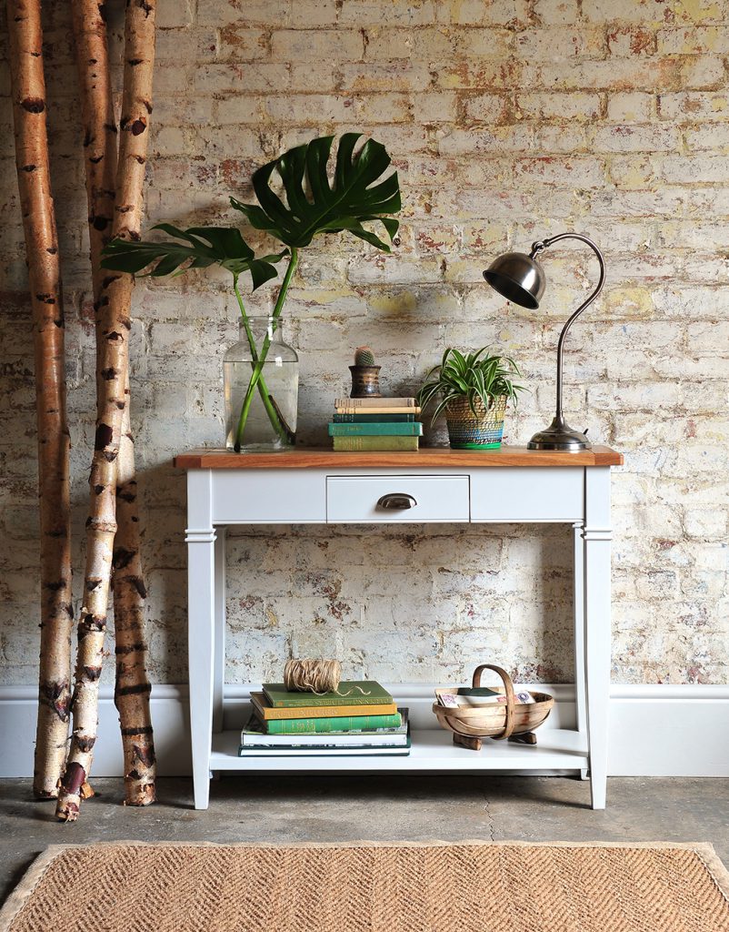 Light grey sideboard, grey furniture, botanical, exposed brick wall
