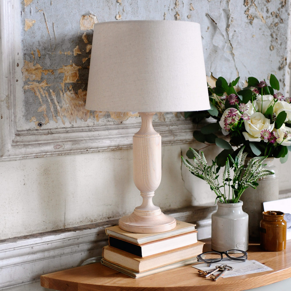 Lamp, flaking wall, books, flowers