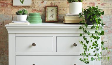 white bedroom furniture, white chest of drawers, brick wall, ivy