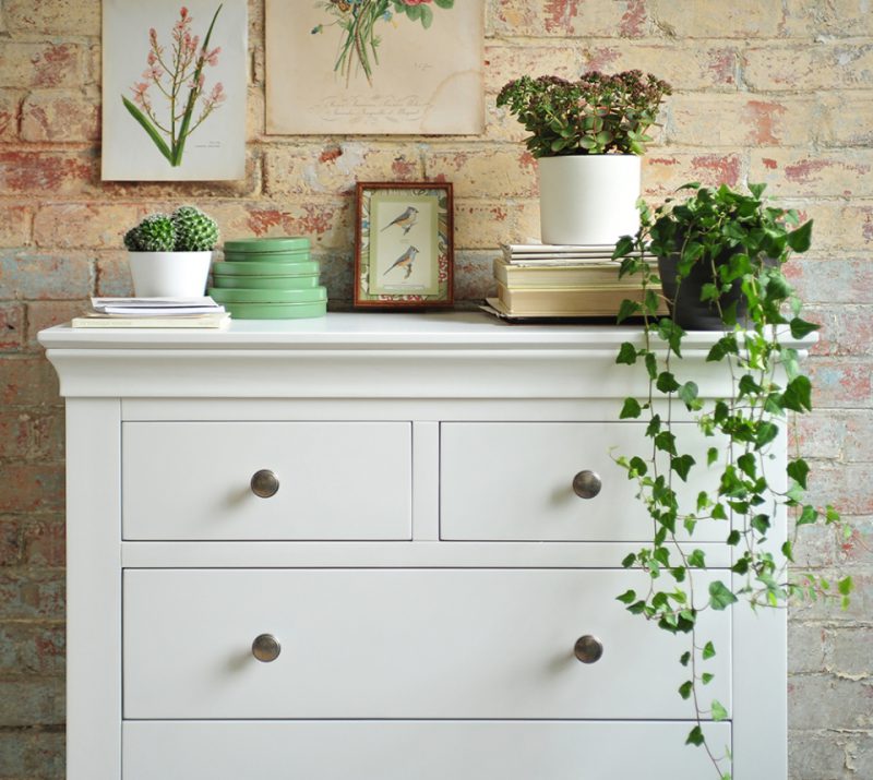 white bedroom furniture, white chest of drawers, brick wall, ivy