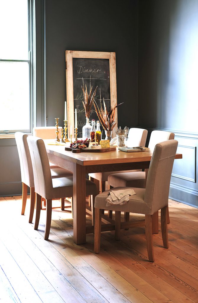 Cream leather chairs, oak table, grey walls, feathers, blackboard