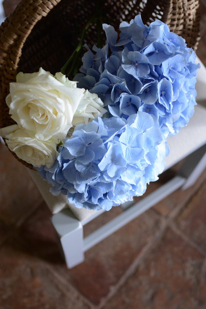 Hydrangeas in a basket, roses, country kitchen, stone floor